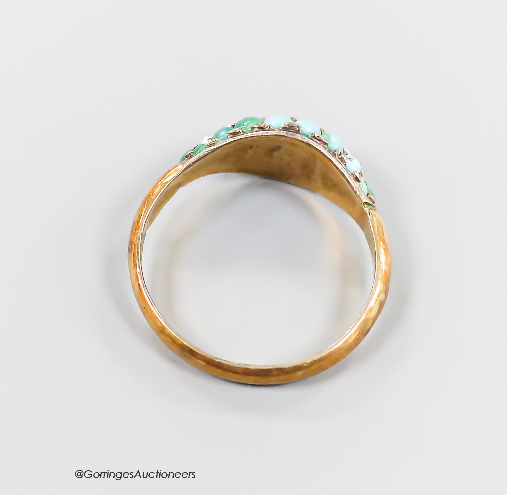 A yellow metal and graduated turquoise and seed pearl set three row half hoop ring, size R, gross 1.7 grams.